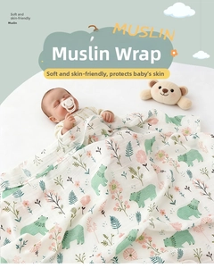 Close-up of soft double-layer cotton gauze baby swaddle with cute bear and floral prints