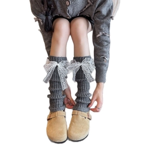 Dark grey knitted leg warmers with white lace bows in a Japanese JK style fashion