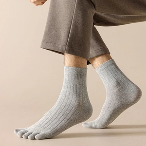 Detail of light grey ribbed cotton five-finger socks showing toe separation and knit texture