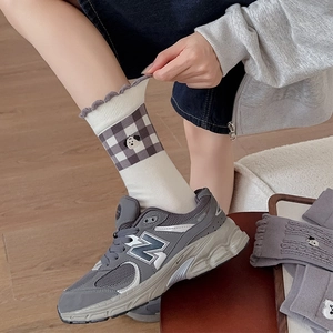 Detail of grey plaid cotton socks with cute puppy embroidery and ruffled lace cuffs