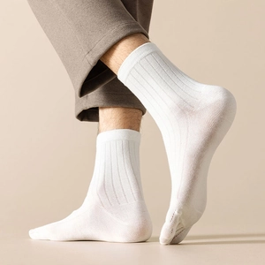 Detailed close-up of white five-toe socks with vertical rib texture on a model's foot