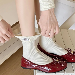 Japanese style white mid-calf socks paired with red patent leather ballet flat shoes