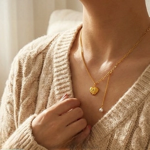 Detail of vintage heart pendant necklace with freshwater pearl on a cable chain