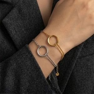 Polished round charm bead bracelets in 18k gold and silver finish on a dark suit