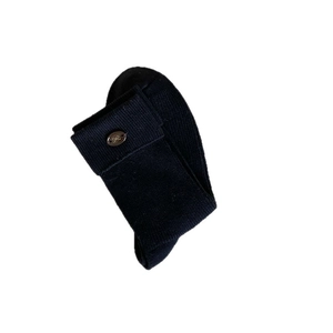 Knitted crew socks with cuff and gold metal bow detail on a plain white background