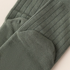 Macro shot of olive green ribbed knit texture and reinforced seam of the men's toe socks