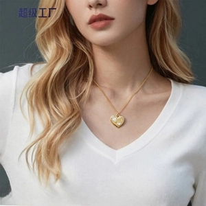 Close-up of golden heart pendant necklace with sparkling white gems on a model