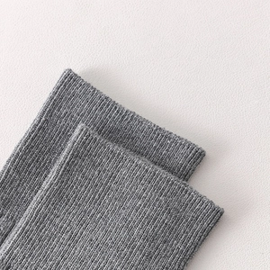 Close-up of gray ballet yoga socks featuring elastic ribbed cuffs for Pilates and dance