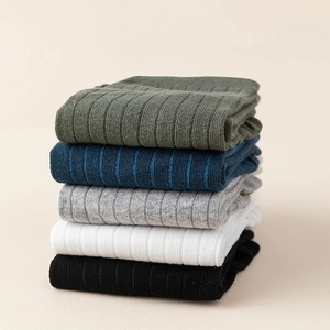 Detailed view of stacked five-toe cotton socks in olive, navy, grey, white and black