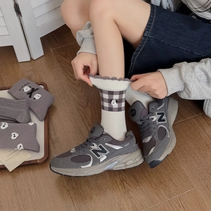 Detail of grey crew socks with cute puppy embroidery and ruffled lettuce edge cuffs