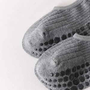 Detail of grey yoga socks featuring honeycomb silicone non-slip grips and knit texture