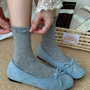 Chaussettes à pois japonaises avec ballerines bleu clair et nœud sur tapis tissé