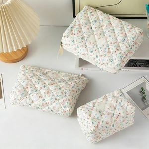 Quilted floral makeup bag set of 3 with pink and blue flower prints on white fabric