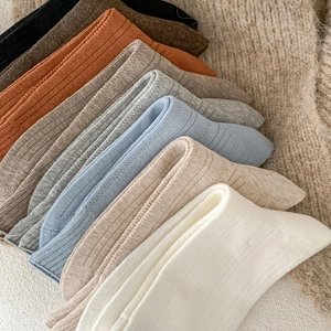 Detailed view of colorful ribbed knit socks in diverse solid colors for autumn and winter
