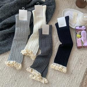 Detail of knitted ribbed calf socks with delicate lace trim in four classic colors