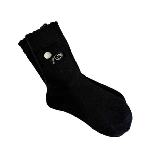 Cute black crew socks with white cat embroidery and fluffy pom-poms for women