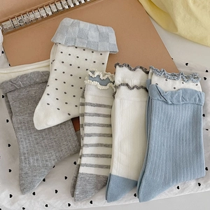 Detailed flat lay of cute Japanese style cotton socks with polka dots and ruffle edges