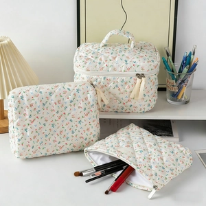 Detailed set of floral quilted makeup bags with tassels in a cozy lifestyle setting