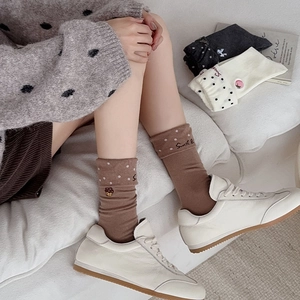Detail of sweet embroidered crew socks with polka dots and ribbed cuffs for women