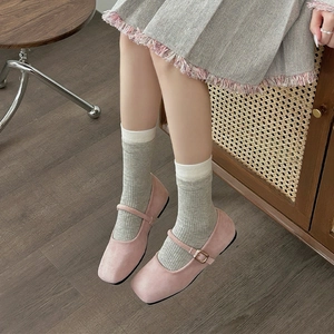 Pink suede square toe Mary Jane shoes styled with grey crew socks and tweed skirt