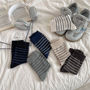 Detailed flat lay of striped mid-calf socks in black, navy, grey, beige and dark coffee