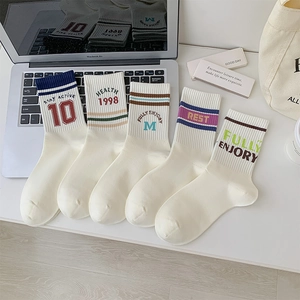 Detail of five-pair set of athletic striped crew socks with vintage embroidery