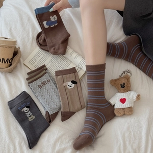 Close-up of assorted Korean style crew socks featuring dog embroidery and retro stripes