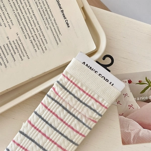 Detail view of pink and grey striped ribbed cotton socks with textured knit finish