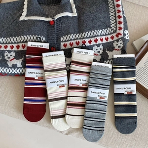 Detail of five-pair set of ribbed cotton socks with retro stripes in assorted colors