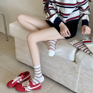 Detail of Korean style striped crew socks featuring red and blue patterns on cotton fabric