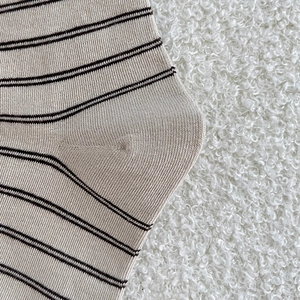 Detail of reinforced heel on vintage striped cotton socks with fine knit texture
