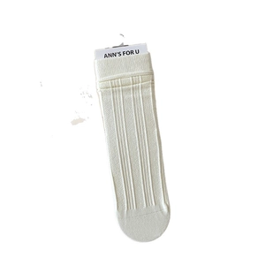 Vertical ribbed knit crew socks in creamy white color for a slim minimalist style