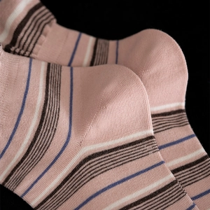Detail of pink cotton ribbed socks with blue and white stripes and soft knit texture