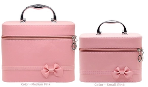 Pink PU leather makeup cases with bow details in medium and small sizes on white background