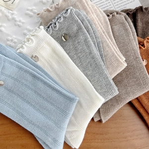 Detailed knit texture and ruffle edge with metal charm on assorted cotton crew socks