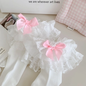 Detail of white Lolita socks featuring layered lace ruffles and pink satin bows