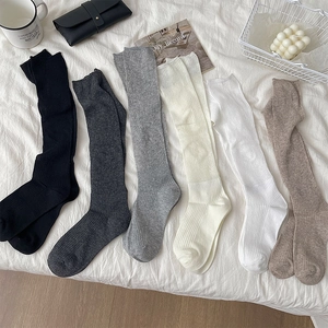 Vertical ribbed calf socks in 6 colors including black, grey, and white on white cloth