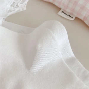 Macro shot of Lolita white socks featuring fine vertical stripes and breathable texture