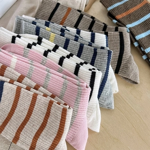 Gros plan de chaussettes en coton rayé avec texture côtelée et motifs de couleurs assorties