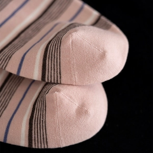 Detailed close-up of seamless toe stitching on striped retro knit cotton crew socks