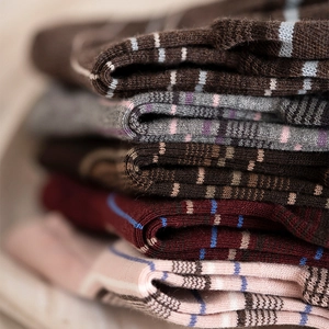 Close-up of thick striped knit cotton socks in various vintage colors with soft texture