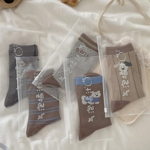 Detail of 5 pairs of cute puppy pattern socks packaged in individual branded zip bags