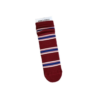 Deep red ribbed crew socks with navy style blue and white stripes in a flat lay view