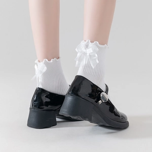 White Lolita lace socks with mesh bows paired with black Mary Jane shoes for sweet Japanese style