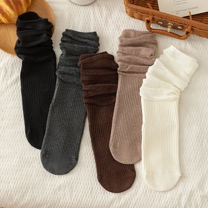 Detail of five pairs of ribbed cotton slouch socks in assorted neutral earthy tones