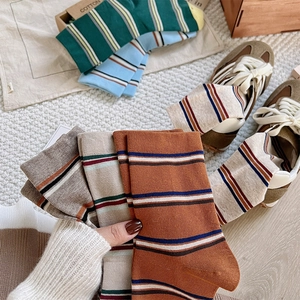 Close-up of retro striped cotton socks set in warm autumn tones and soft knit texture