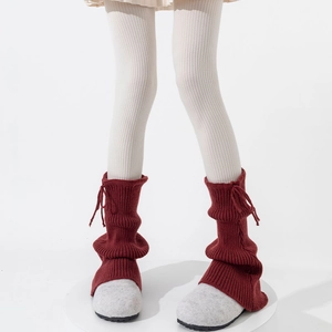 Detail of burgundy ribbed knit leg warmers with adjustable drawstring tie design