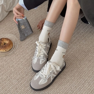 Grey suede sneakers with lace trim and cute bear striped mid-calf socks for women