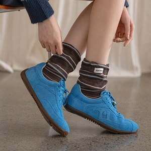 Blue suede casual sneakers with textured H logo and striped crew socks for autumn
