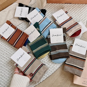 Detailed flat lay of colorful striped cotton knit socks in warm vintage tones
